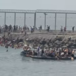 Migrants attempting to enter Spain’s Ceuta enclave from Morocco as security officers reinforce the border