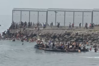 Migrants attempting to enter Spain’s Ceuta enclave from Morocco as security officers reinforce the border