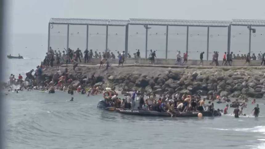 Migrants attempting to enter Spain’s Ceuta enclave from Morocco as security officers reinforce the border