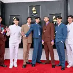 BTS receiving an award as Recording Academy CEO Harvey Mason Jr. responds to their Grammy decision