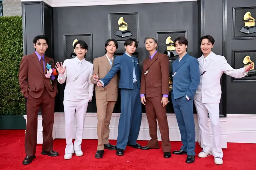 BTS receiving an award as Recording Academy CEO Harvey Mason Jr. responds to their Grammy decision
