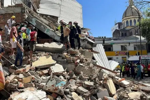Rescue workers search through collapsed buildings after a magnitude 7.4 earthquake struck Colombia