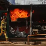 Firefighters battle flames at a Kyiv book market after a Russian strike
