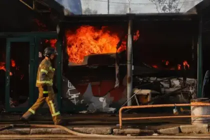 Firefighters battle flames at a Kyiv book market after a Russian strike