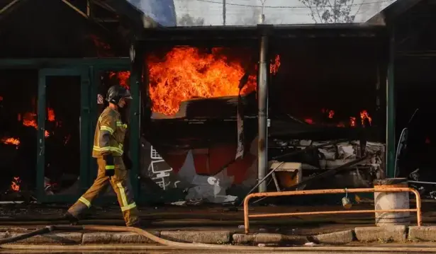Firefighters battle flames at a Kyiv book market after a Russian strike