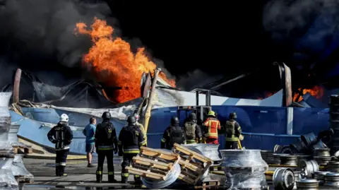 Smoke rising after a Russian drone strike on a weapons depot near Kyiv