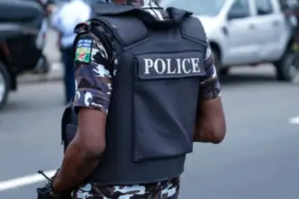 Abia State Police officers following the arrest of a suspected child trafficker and rescue of six children