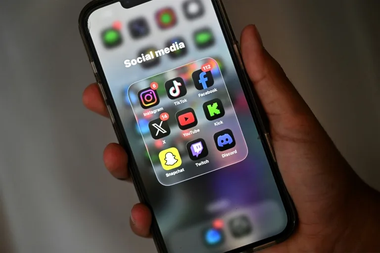 Teenager using a smartphone as New Zealand proposes a social media ban for children under 16