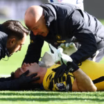 Chelsea goalkeeper Emiliano Martinez receiving medical treatment after colliding with Everton defender Jarrad Branthwaite